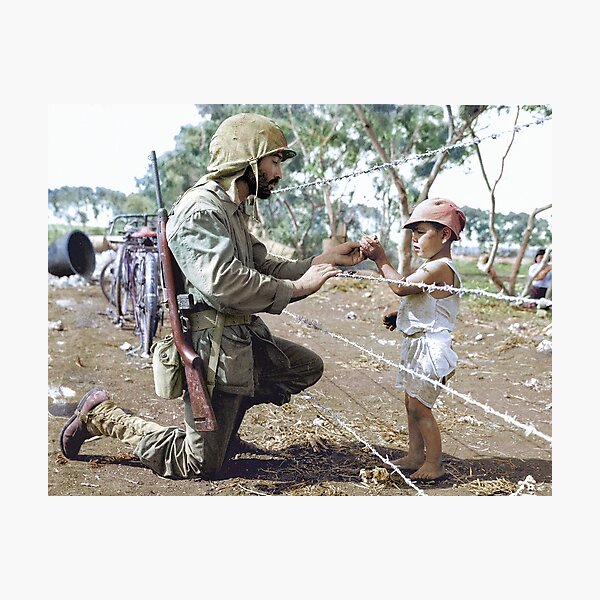 Item preview, A U.S. Marine reaches through the barbed wire of a civilian containment area to give a young Japanese boy candy during the Battle of Tinian.  designed and sold by Marina Amaral.