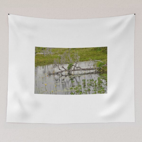 Item preview, Old Fallen Branch across a pond, yellow flowers blooming designed and sold by 2CrabbySisters.