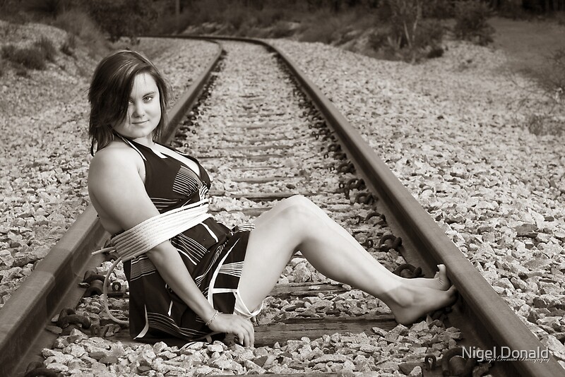 "Tied up on train tracks" by Nigel Donald Redbubble