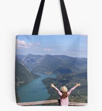 happy little girl with hands up on mountain viewpoint Tote Bag