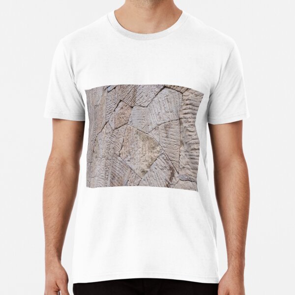Item preview, Angle view on brown wall of stone blocks of irregular shape and uneven surface for use as a background close up designed and sold by vladromensky.