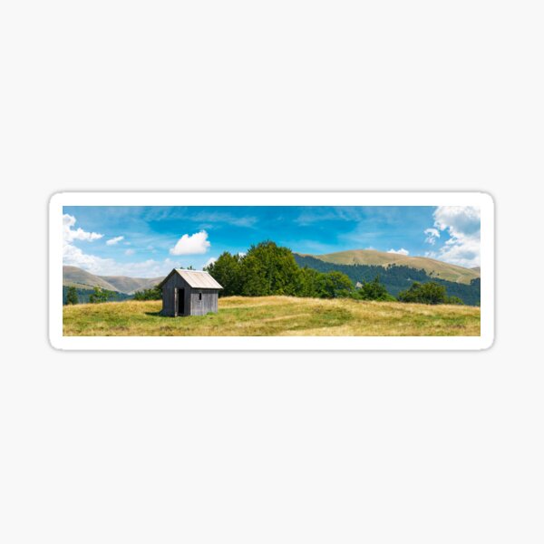 wooden hut on a grassy meadow Sticker