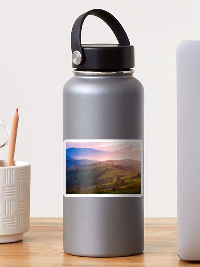 Thumbnail 1 of 3, Sticker, purple sunrise in foggy countryside designed and sold by mike-pellinni.