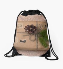 Christmas or New Year gift boxes wrapped in kraft paper with fir branch on wooden background. Drawstring Bag
