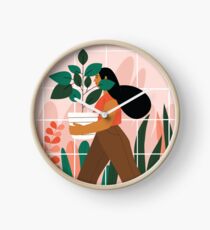 Beautiful girl with plant in pot Clock