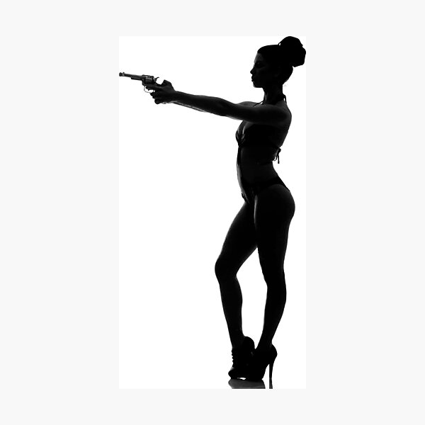 Silhouette of woman with pistol in a bathing suit Photographic Print