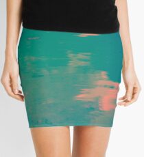 Water in different colors of blue, pink and orange Mini Skirt