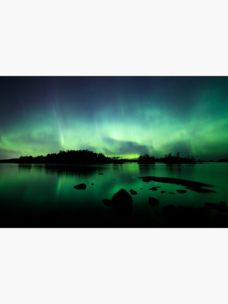 Beautiful northern lights over lake by Juhku