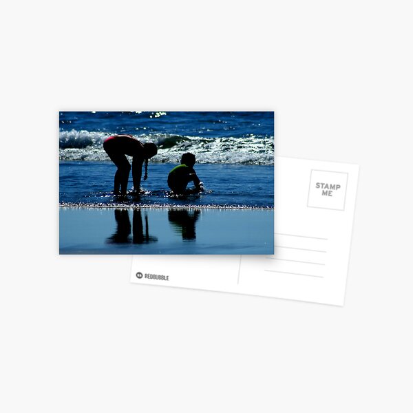 two children playing in the ocean waves by CheyAnne Sexton Postcard