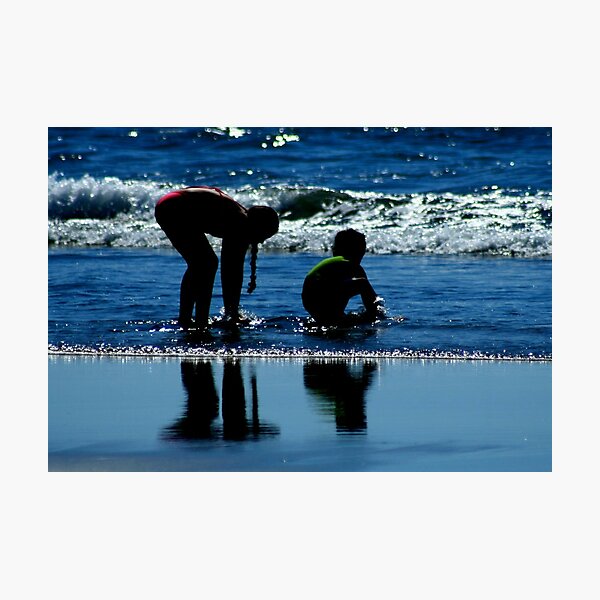 two children playing in the ocean waves by CheyAnne Sexton Photographic Print
