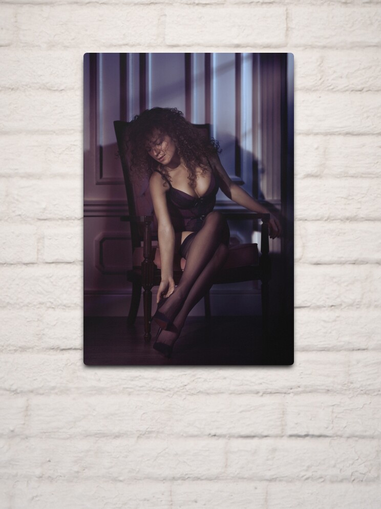 Boudoir portrait of a woman sitting in a chair in lingerie and