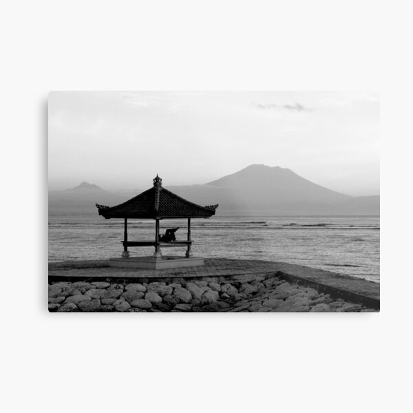 Lone figure in beachside pagoda, sacred mountain Gunung Agung in background. Bali, Indonesia Metal Print