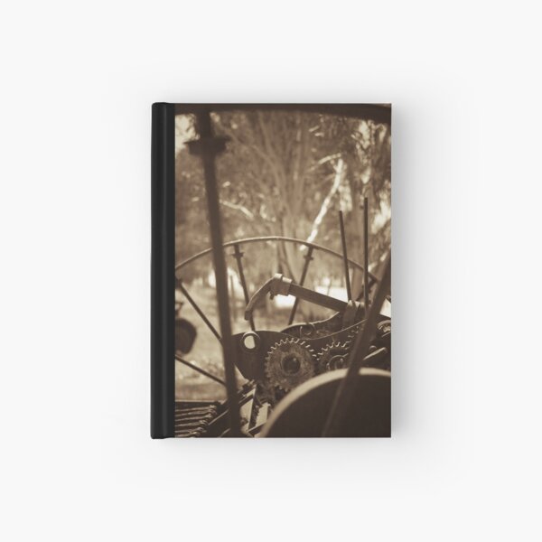 Rusting farm equipment - sepia Hardcover Journal