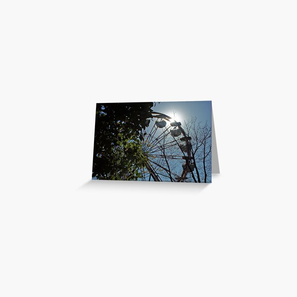 Sun behind the ferris wheel Greeting Card