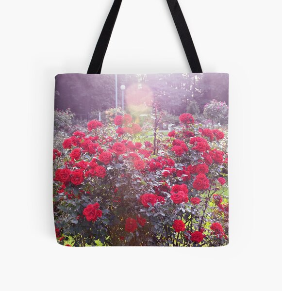 Red Rose Bush in a Sunlit Rose Garden All Over Print Tote Bag