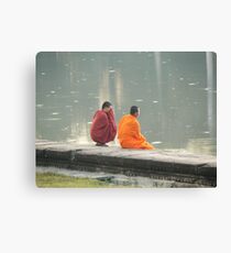 Two monks having a quite minute at sunset at Angkor Wat Cambodia Canvas Print