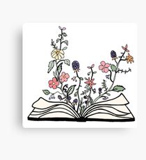 Blumen wachsen aus Buch Leinwanddruck