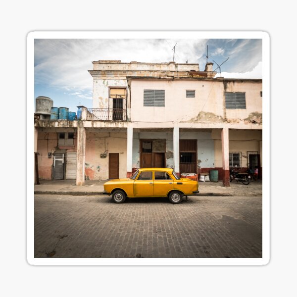 Bright yellow vintage car in La Havana, Cuba. Sticker