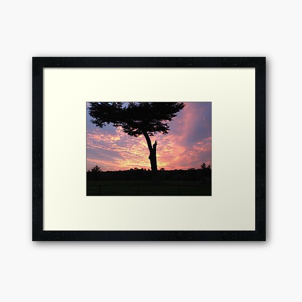 silhouette in molten sky Framed Art Print