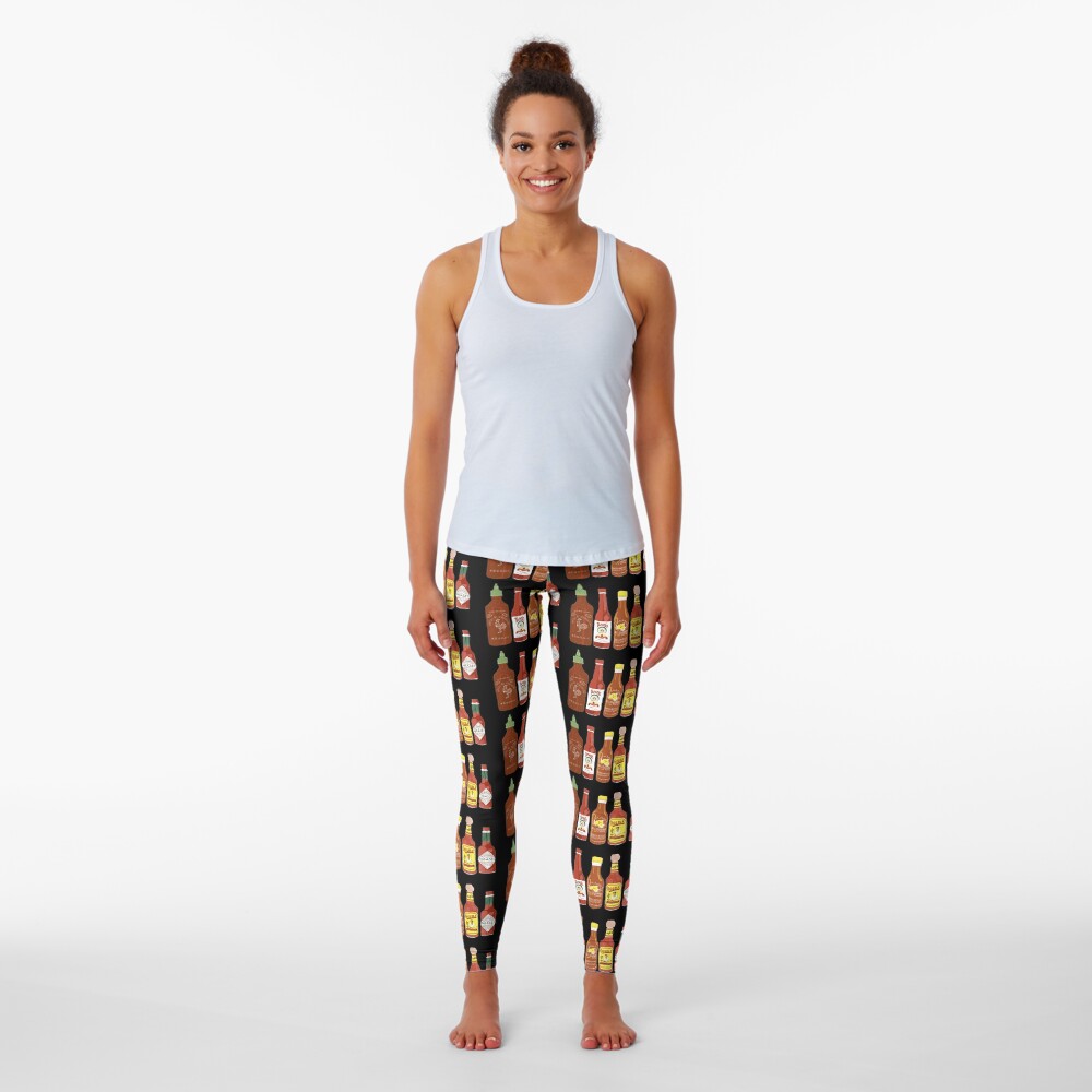 Spicy! Check out these hot sauces on black background Leggings