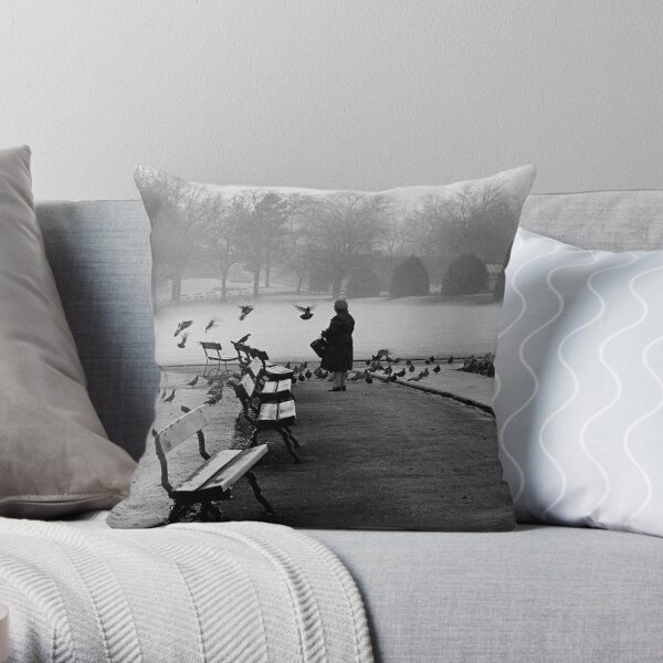 Shy woman feeding pigeons Throw Pillow
