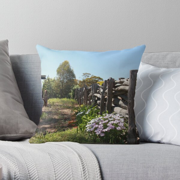 Flowers by the fence Throw Pillow