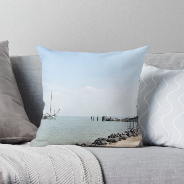 Sailing boat arriving at the lighthouse Throw Pillow
