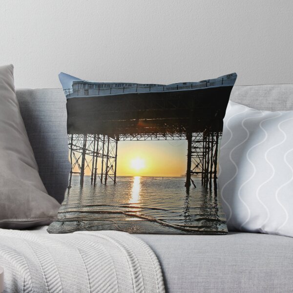 Sun setting through Brighton Pier Throw Pillow