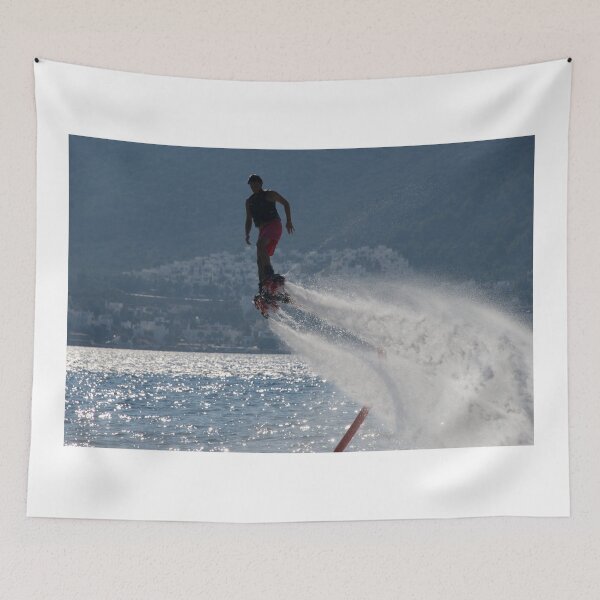 Item preview, Flyboarder followed by spray over backlit sea designed and sold by Nick Dale Photography.