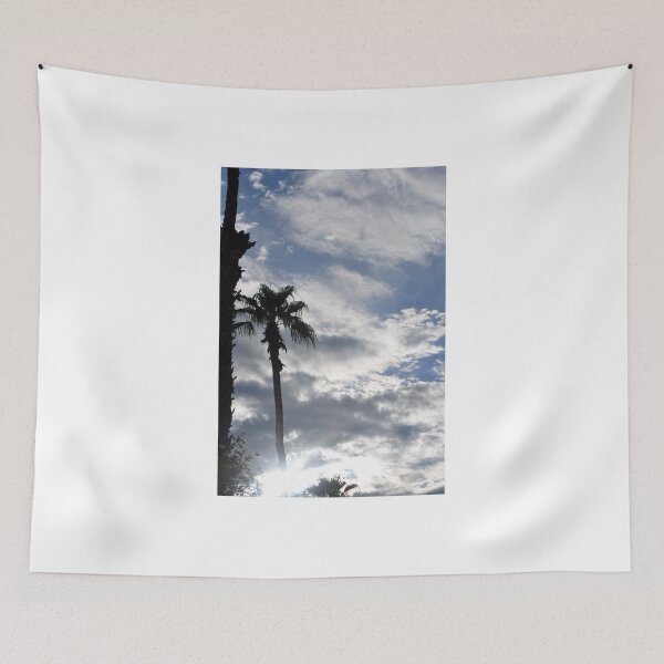Item preview, PALM TREE SILHOUETTED AGAINST CLOUDY BLUE SKY designed and sold by JAYMILO.