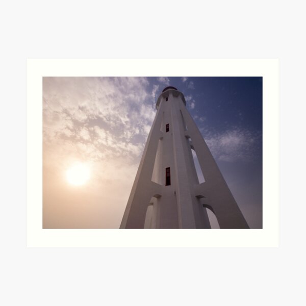 Modern lighthouse with fading sun Art Print