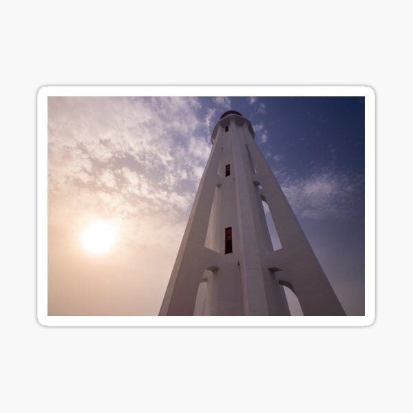 Modern lighthouse with fading sun Sticker