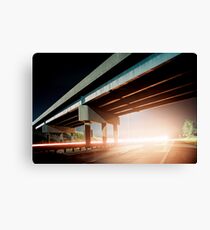Car gliding under the highway Canvas Print