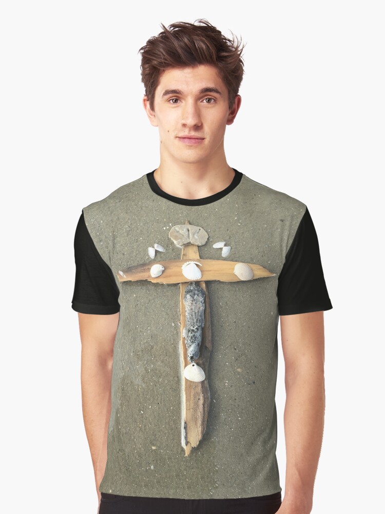 Thumbnail 1 of 5, Graphic T-Shirt, Driftwood cross on beach sand - From ccnow.info designed and sold by sdawsoncc.
