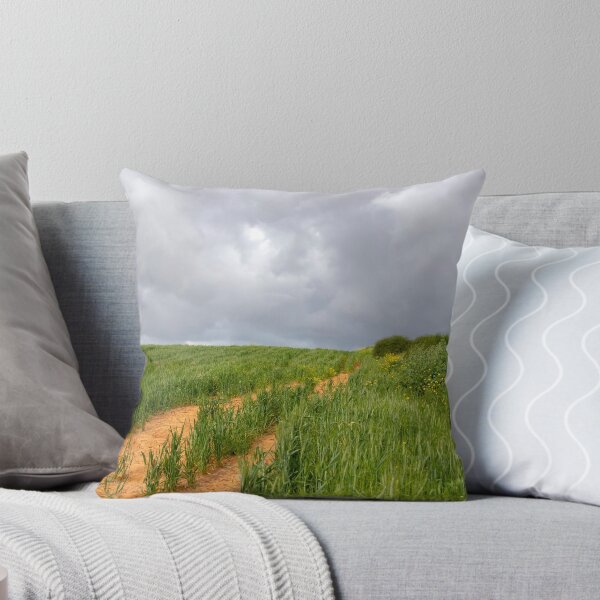 Item preview, A field of green wheat against the backdrop of a stormy sky. Sideways yellow flowers and bushes. designed and sold by EG Creativity Art.