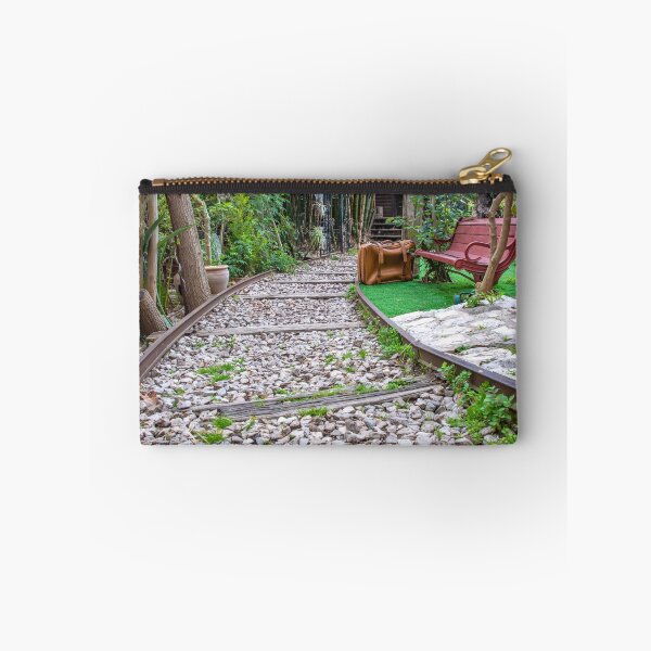 Item preview, Old railway rails passing next to a red bench and a yellow road suitcase. Travel designed and sold by EG Creativity Art.