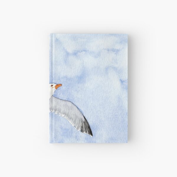 Seagull flying under a blue sky Hardcover Journal