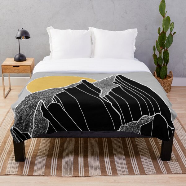 The dark peaks under the golden sun Throw Blanket