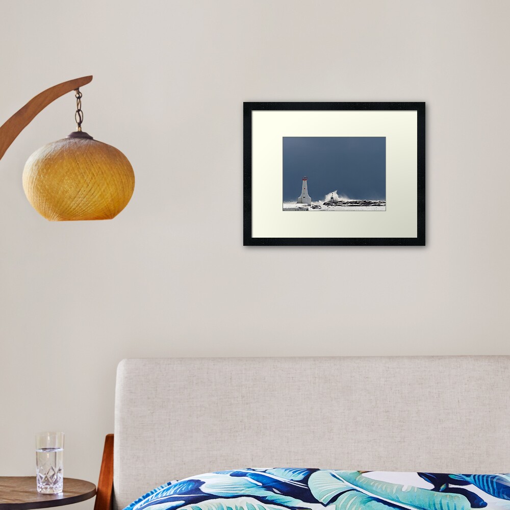 Frozen Lighthouse Facing the Storm Framed Art Print