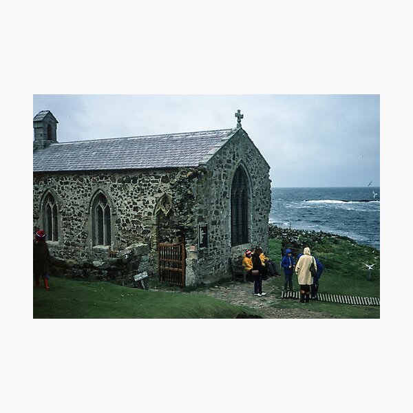 Item preview, People outside 1370 church in memory of St Cuthbert who died here 687 on Farne island off Sea Houses Bamburgh Northumberland England 19840528 0019m designed and sold by Fred Mitchell.