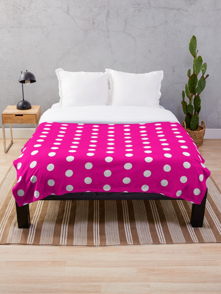 pink blanket with white polka dots