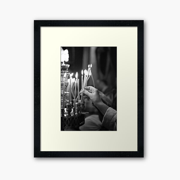 Lighting a candle Framed Art Print