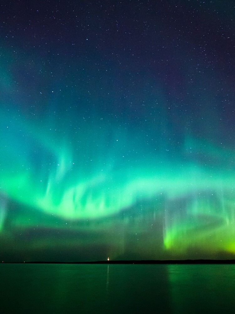 Thumbnail 3 of 3, Drawstring Bag, Northern lights glow over lake designed and sold by Juhani Viitanen.