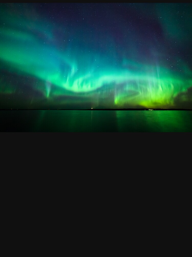 Northern lights glow over lake by Juhku