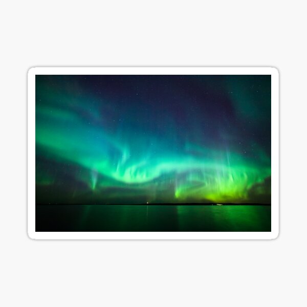 Northern lights glow over lake Sticker