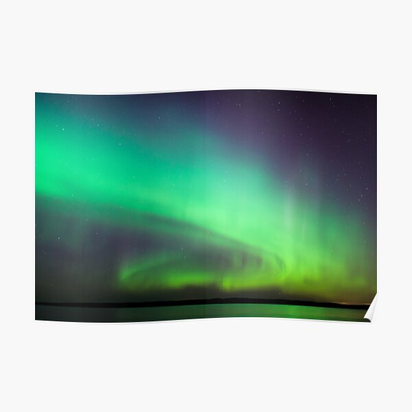 Northern lights over lake in Finland Poster