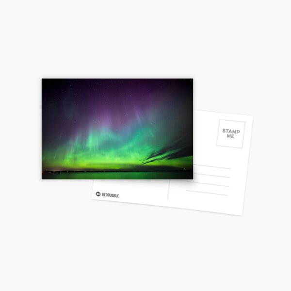 Beautiful northern lights over lake in Finland Postcard