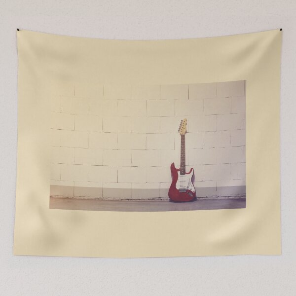 Item preview, Red electric guitar against white brick wall designed and sold by Lukasz Szczepanski.