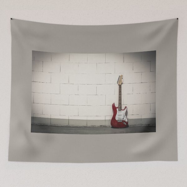 Item preview, Red electric guitar against white brick wall designed and sold by Lukasz Szczepanski.