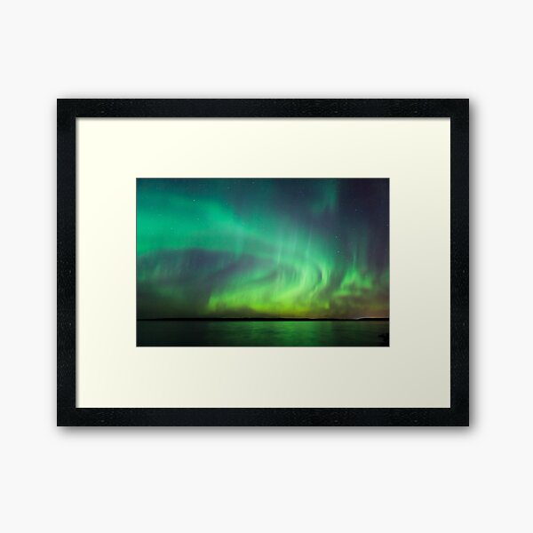 Northern lights over lake in Finland Framed Art Print
